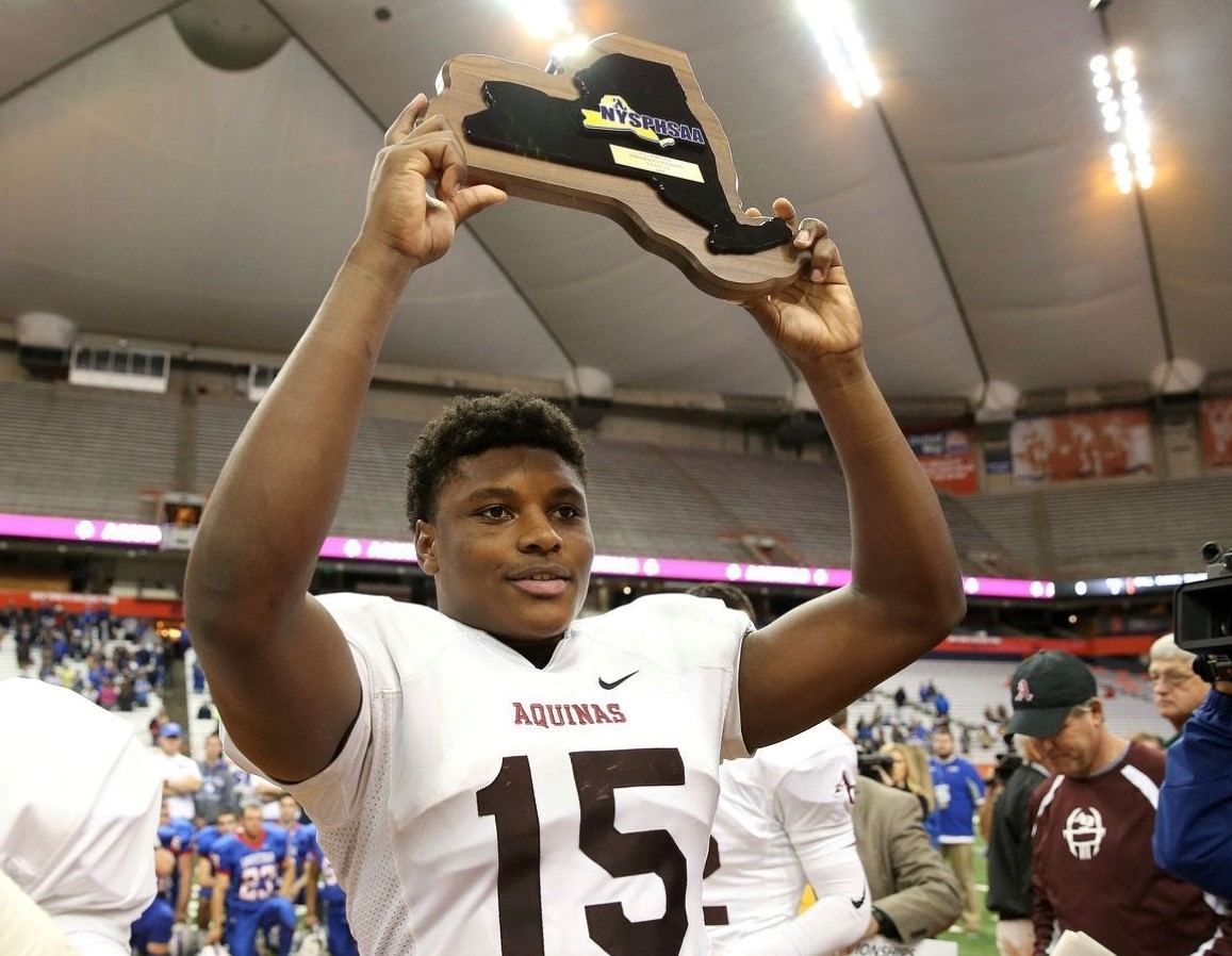 Jamir Jones '16 holds up the state championship trophy